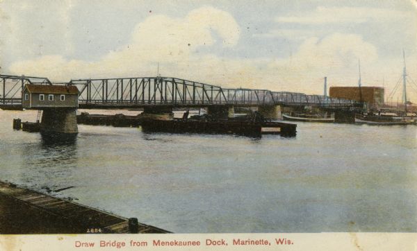 View from dock toward the drawbridge. Caption reads: "Drawbridge from Menekaunee Dock, Marinette, Wis."