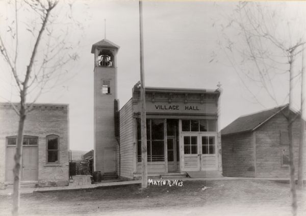 Village Hall in Marion with a bell tower on the left side of the building. Caption reads: "Marion, Wis."
