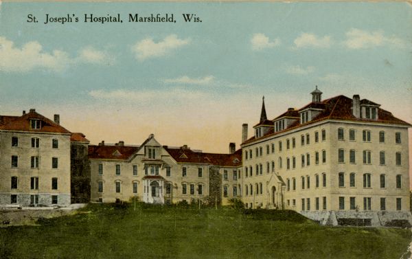View across lawn towards St. Joseph's Hospital. Caption reads: "St. Joseph's Hospital, Marshfield, Wis."