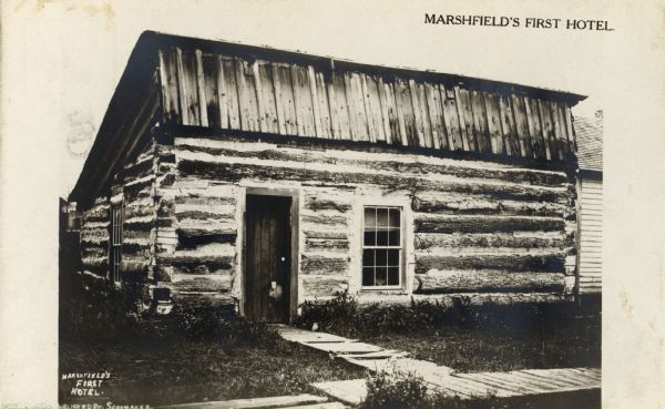 The bare structure of Marshfield's first hotel. Caption reads: "Marshfield's First Hotel."