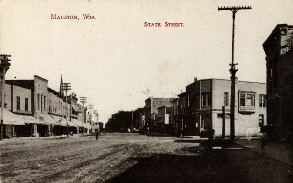View down wide, unpaved street with businesses and storefronts on both sides. Captions read: "Mauston, Wis." and "State Street."