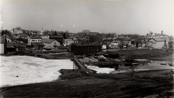 View of Mayville behind the frozen, snow-covered river.