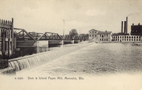 The Island Paper Mill and dam in Menasha. Caption reads: "Dam & Island Paper Mill, Menasha, Wis."