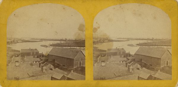Stereograph of an elevated view of the industrial section along the Fox River in Menasha. During this period the millers in Menasha were beginning to invest in the paper industry rather than in flour, as they had previously. Minneapolis was becoming the center for milling.