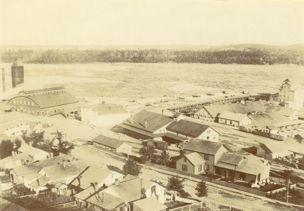 Elevated view of Red Cedar (or Menomonie) River and the Knapp, Stout & Co., mills from the top of present day Meadow Hill Dr. looking Southeast.