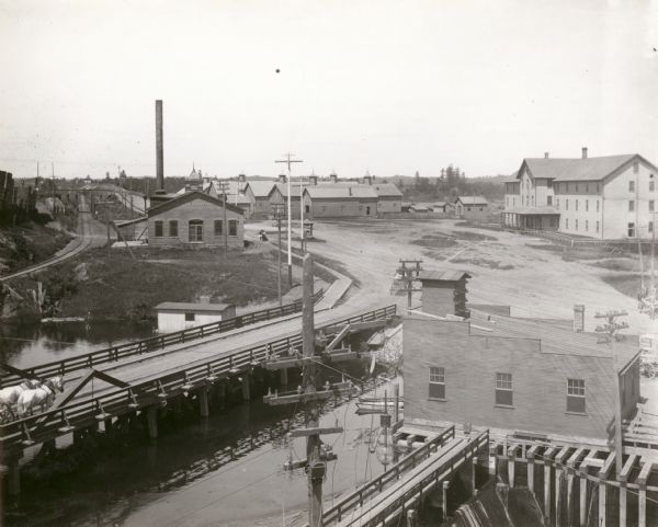 Elevated view looking north towards Menomonie, the Knapp, Stout and Company lumber mills.
