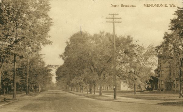 View down center of street. Caption reads: "North Broadway, Menomonie, Wis."