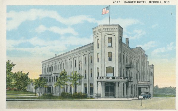 View across street towards the Badger Hotel. Caption reads: "Badger Hotel, Merrill, Wis."
