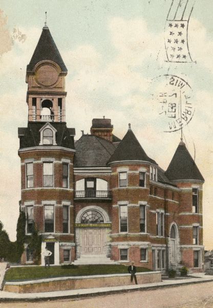 Merrill's City Hall and Library. Men are posing in front.