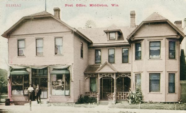 Exterior of the Post Office. Two people are standing at the entrance on the left. Caption reads: "Post Office, Middleton, Wis."