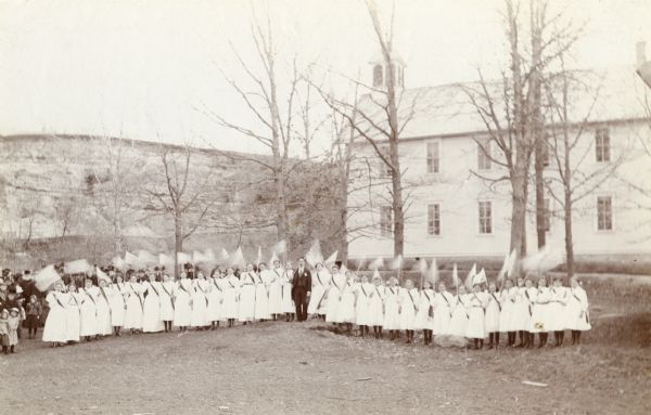 Students standing outside of Middleton Grade School, at its original location at the southwest end of Middleton near a stone quarry. The building was moved to Hubbard street in downtown Middleton and used as Village Hall until 1964.