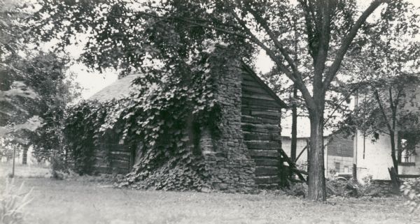 A view of the cabin on the property of the Milton House, which was a part of the Underground Railroad prior to the abolition of slavery. The house was built in 1845 by Joseph Goodrich and turned into an Inn. The frame house and log cabin behind the Inn were also built by Goodrich, along with the Milton House Tavern. The Milton House was later taken over and turned into a museum.