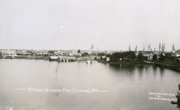 Elevated view of Minocqua from Clawson's Hill. Caption reads: "Minocqua Wisconsin From Clawson's Hill."