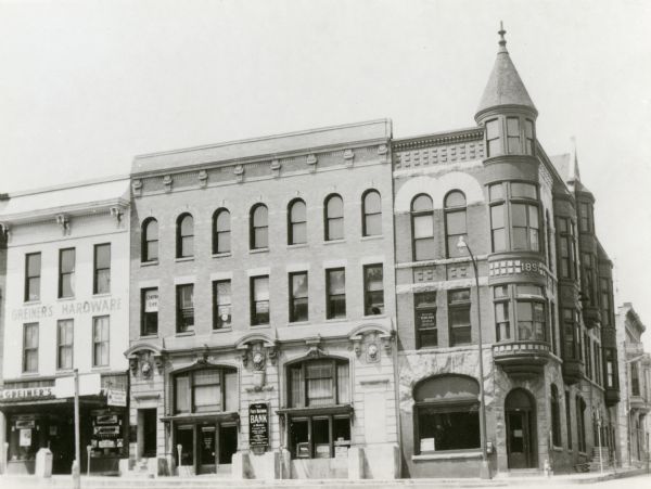 The Jacob Karlan block, built in 1893 on the north side of Monroe Street. The Karlan block was erected on the site of the old United States Hotel, adjoining First National Bank. The old frame hotel building was divided into two sections: one portion moved to the north on Payne (9th) Street and was used as a livery stable for many years; the other section moved a half-mile to the west and was faced with brick to become a residence. The latter section of building is now on Russell (10th) Street and is the home of Mr. and Mrs. Carl Maurer (1973).
Jacob Karlan Sr., pioneer cheesemaker and Monroe cheese dealer, erected his business block as an investment and housed his cheese firm offices in a portion of it. The first floor corner section was formerly occupied by the famed Headquarters Salloon for 50 years. The block was razed in 1954 to make way for the new First National building. Karlan had also built an annex to his block for his cheese operations. This unit, connected by a tunnel, was razed in the 1960's.