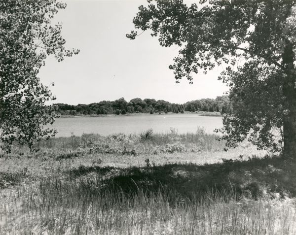 View of Ennis Lake, also known as Fountain Lake, located in the John Muir Memorial Park near Montello. As a boy, John Muir lived with his family on the shores of Fountain Lake from 1849-1857. Muir Park, which is owned by Marquette County, was named a State Natural Area in 1972, and Fountain Lake Farm was designated a National Historic Landmark on June 21, 1990.