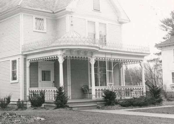 The Steinman residence, built in 1902, and owned by Christ Yuassi in 1950. View across lawn towards the front of the house, showing the porch trim and other details.