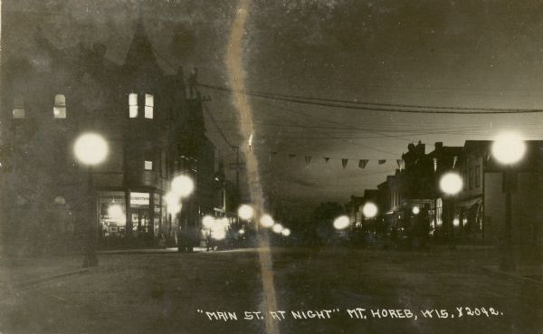 A view of Main Street at night. Caption reads: "'Main St. at Night' Mt. Horeb, Wis."