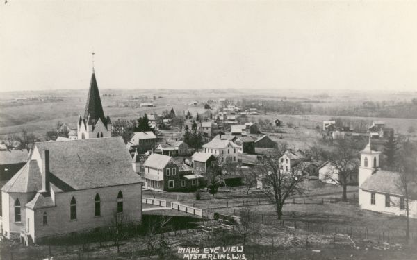 Elevated view of the town with a church building in the left foreground. Caption reads: "Birds Eye View Mt Sterling, Wis."