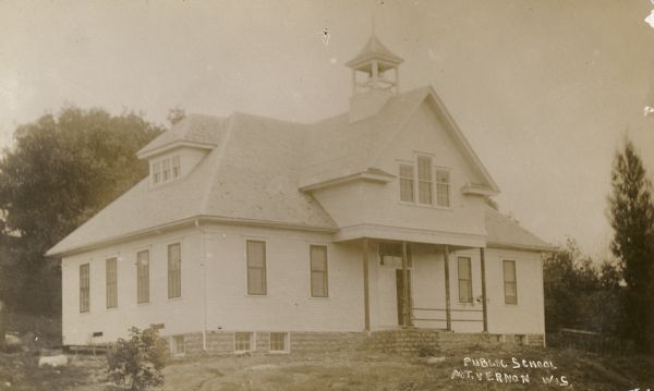 Exterior view of the public school. A bell tower is on the roof. Caption reads: "Public School, Mt. Vernon, Wis."