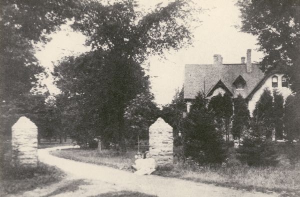 Nashotah Mission, Shelton Hall and main entrance about 1920(?) Two young girls sitting in foreground.