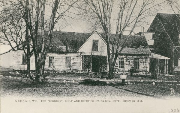 Front view of the home of Janes Duane Doty on Doty's Island, "the loggery." Caption reads: "Neenah, Wis. The 'Loggery', built and occupied by ex-Gov. Doty. Built in 1843."