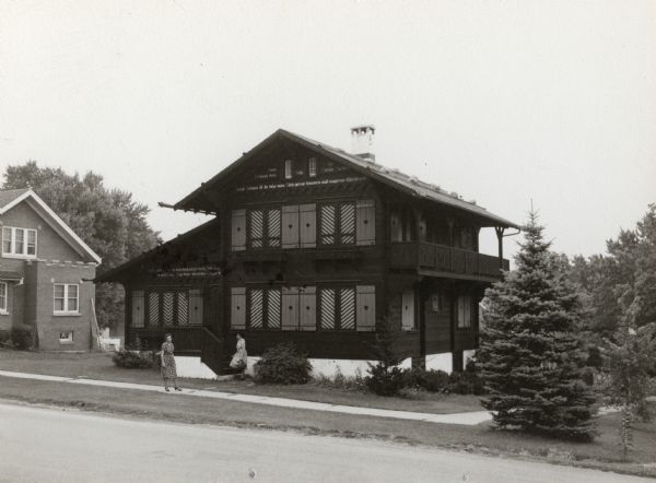 Barlow "Chalet of the Golden Fleece," New Glarus, Wisconsin. Home of Edwin Barlow, now city museum. Two women are standing in front of the house.