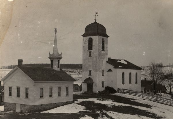 Slightly elevated view of the Swiss Reformed Church, destroyed in 1899. Snow is on the ground.