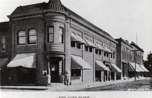 View of front of the Cash Block, with one person standing in front of the building.