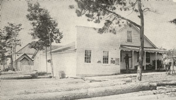 General store and post office. Hans Johsnon, Newport's founder, is shown on the porch. Logs are stacked in the foreground. The post office was established on October 17, 1882, with Johnson as postmaster. It was discontinued on April 30, 1904.