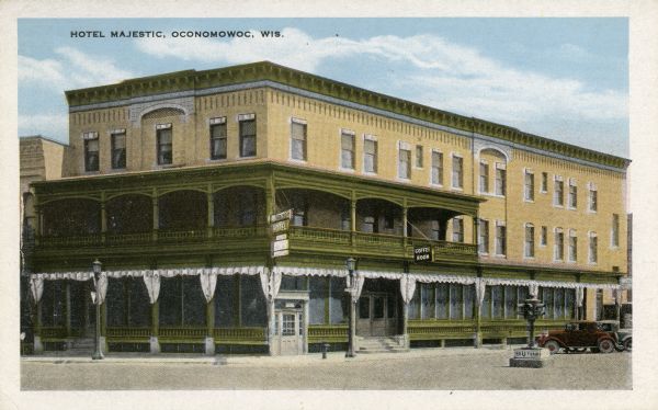 Hotel Majestic. Caption reads: "Hotel Majestic, Oconomowoc, Wis." An advertisement on the back reads: "Located on intersection of Highways 19 and 67. Situated in beautiful Lake Region of Wisconsin. Boating, bathing, fishing, and golfing. Private bathing beach. Coffee room in hotel featuring waffles, toasted sandwiches and A La Carte orders. Open day and evening.  F.W. Long, Mgr."