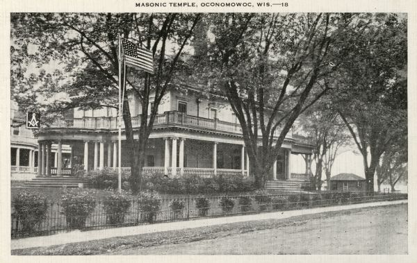 Masonic Temple, with American flag flying in yard. Caption reads: "Masonic Temple, Oconomowoc, Wis."