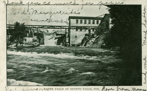 Falls of the Oconto River with footbridge. Caption reads: "The Falls at Oconto Falls, Wis." 