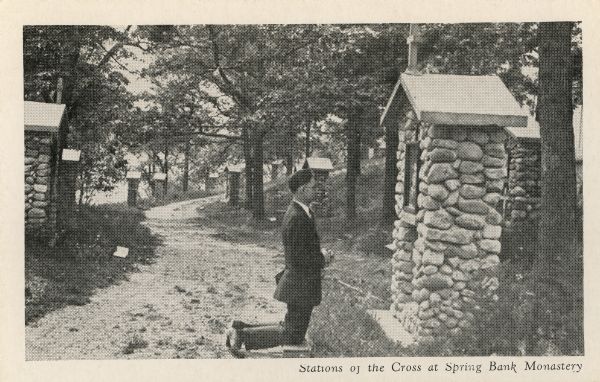 Spring Bank monastery. Man kneeling in from of one of the Stations of the Cross. This is probably part of the Cistercian monastery. Caption reads: "Stations of the Cross at Spring Bank Monastery."