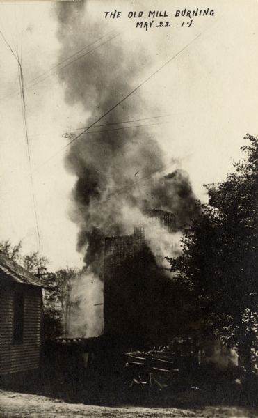 Caption reads: "The Old Mill Burning."