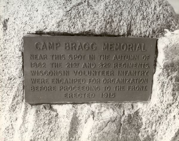Close-up of the plaque on the memorial to Camp Bragg, located in Menominee Park. It reads: "Camp Bragg Memorial Near this spot in the autumn of 1862 the 21st and 32d regiments, Wisconsin Volunteer Infantry, were encamped for organization before proceeding to the front. Erected 1915".