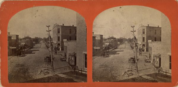 Stereograph. In the right background is the building of the Trade Reporter newspaper at the corner of Main and High Streets; across the street from it is J.N. Grill's Flour and Feed Store.