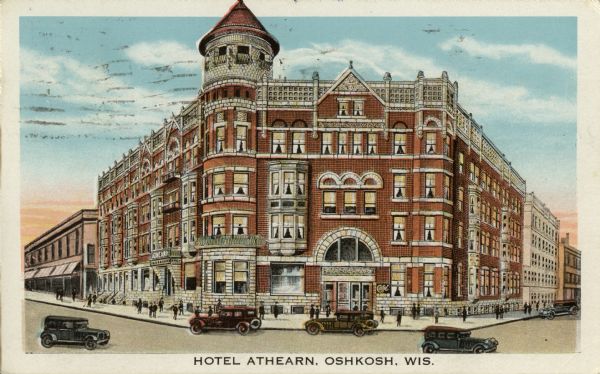 View across intersection towards the Hotel Athearn, which was built in 1891 across the street from the Grand Opera House. It was designed by the same man that designed the Grand Opera House, William Waters. It housed many of the performers from the opera house and was razed in 1965. Caption reads: "Hotel Athearn, Oshkosh, Wis."