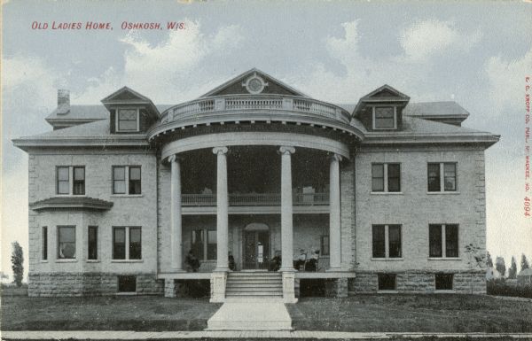 Exterior view of the Old Ladies Home. Women are sitting on the porch. Caption reads: "Old Ladies Home, Oshkosh, Wis."