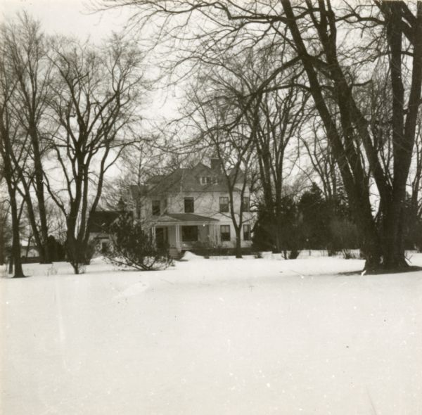 A distant view across snow-covered towards the residence of J.H. Osborn. Osborn moved to Oshkosh in 1844 from New York City. He farmed, traded real estate, and was involved in local politics.