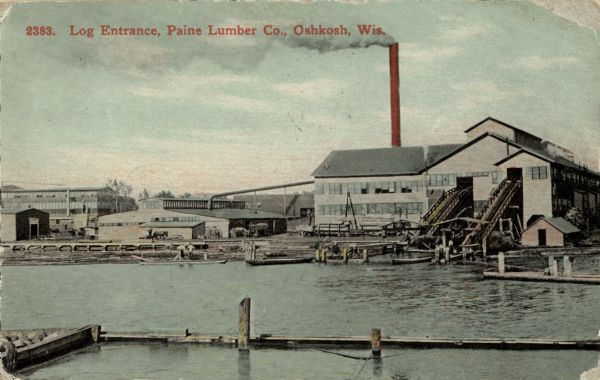Log entrance of the Paine Lumber Co. Edward L. Paine founded the lumber mill in 1853 on the east bank of the Fox River. Caption reads: "Log Entrance, Paine Lumber Co., Oshkosh, Wis."