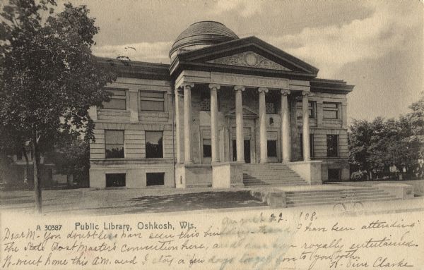 Exterior view of the Oshkosh Public Library. The cornerstone was laid in May of 1899, and the library was finally complete in September of 1900. Located on Washington Avenue. Caption reads: "Public Library, Oshkosh, Wis."
