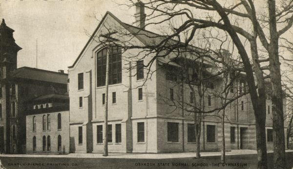 The gymnasium of Oshkosh State Normal School. This gynasium was regarded as the best equipped in the nation, and was constructed during the school presidency of John H. Keith. Caption reads: "Oshkosh State Normal School — The Gymnasium".