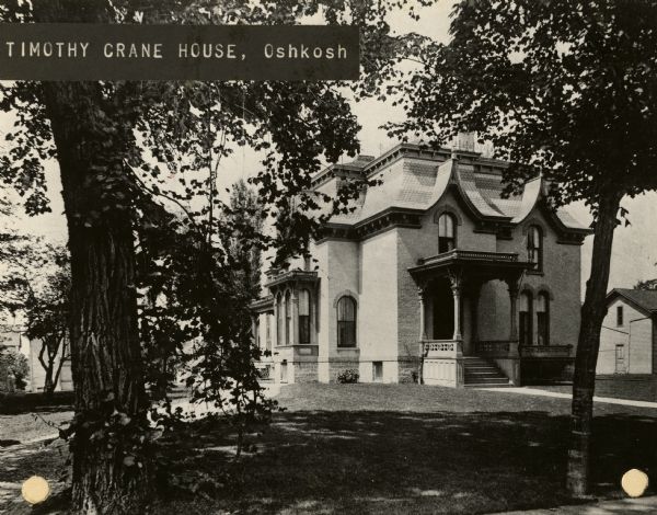 View from sidewalk of the Timothy Crane house. Caption reads: "Timothy Crane House, Oshkosh".