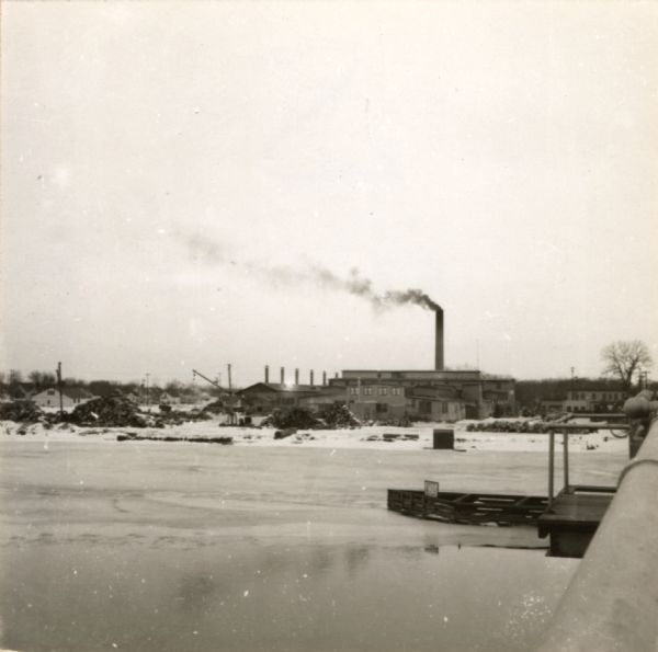 View from Oshkosh Avenue across icy river towards the Pluswood factory in the distance.