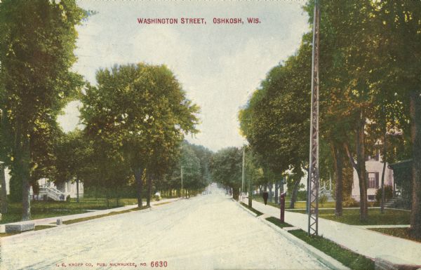 View down Washington Street. There is a tall, narrow tower in the right foreground near the curb. Caption reads: "Washington Street, Oshkosh, Wis."