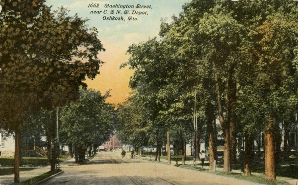 View down center of tree-lined street. Caption reads: "Washington Street, near C. & N. W. Depot, Oshkosh, Wis."