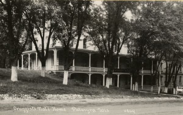 View across road towards the Druggists National Home. Caption reads: "Druggists Nat'l Home Palmyra, Wis."