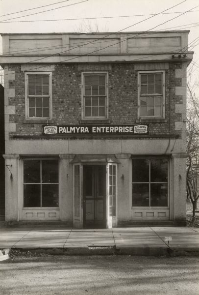 The Palmyra Enterprise Building. Sign reads: "Printing of All Kinds" and "A Happy Advertising Medium."