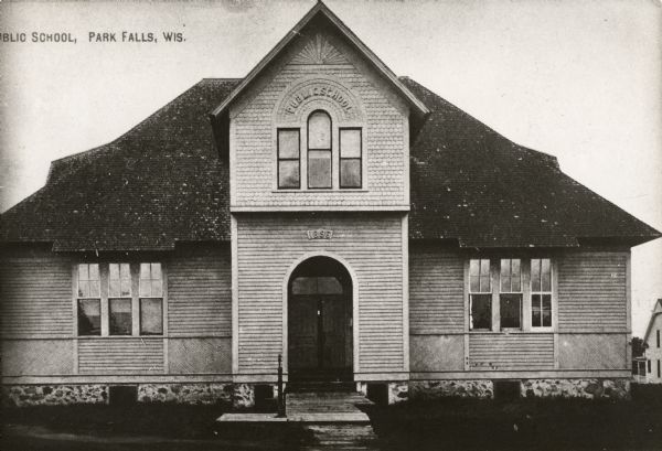 View of the front of the public school established in 1896. Caption reads: "Public School, Park Falls, Wis."