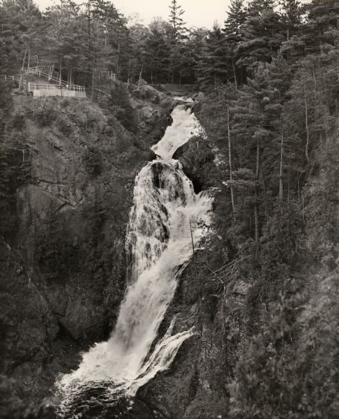 Big Manitou Falls on the Black River. It is referred to as the "lower falls" in the park. This 165-foot waterfall is recognized as the highest in the state.
